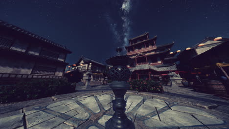 night view of a traditional chinese town with a milky way in the sky