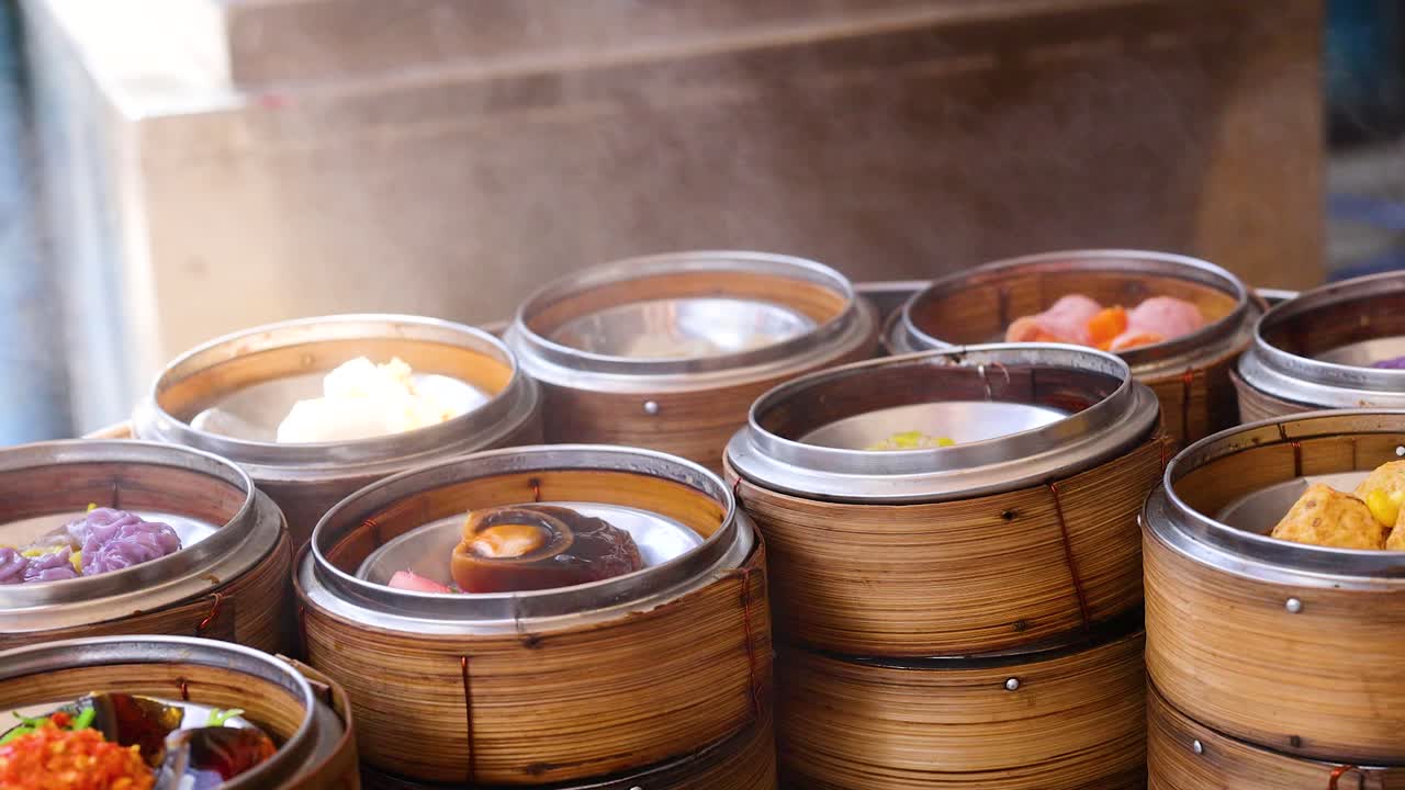 Bamboo baskets filled with colorful dim sum steam gently in a bustling Phuket market, showcasing vibrant culinary artistry