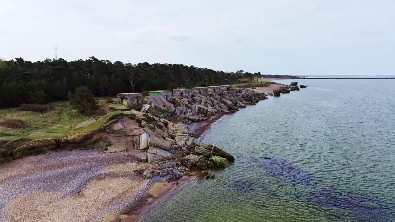 Dramatic aerial footage showing old war ruins, coastline erosion, Liepaja Latvia
