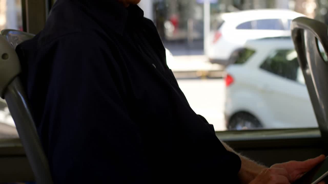 Ældre mand taler i mobiltelefon, mens han rejser med bus 4k