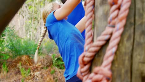 fit people climbing a net during obstacle course 4k