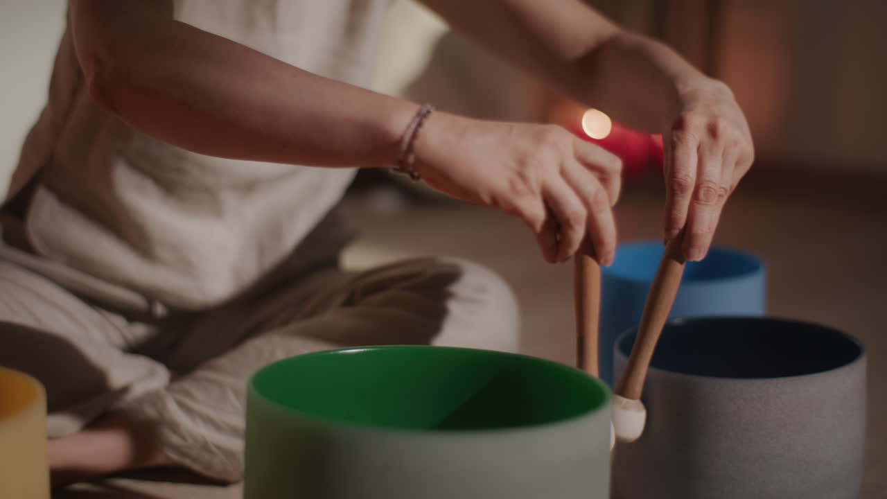 Woman Playing Singing Bowls for Sound Healing