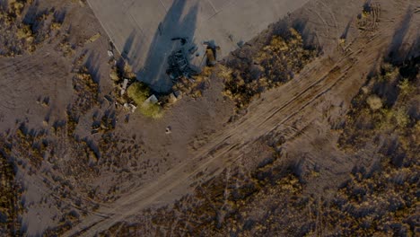 abandoned propellor plane in desert field aerial