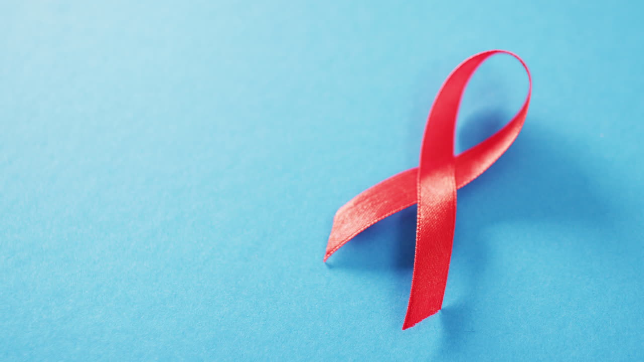 vídeo de vih rojo o cinta de concienciación sobre el sida en fondo azul con espacio para copiar.