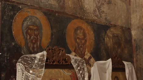 close up of an ancient hagiography of three saints in a greek orthodox church