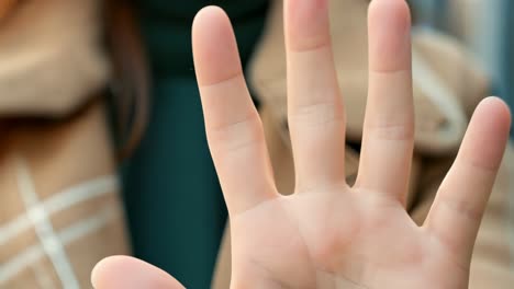 a woman is holding her hand up in the air