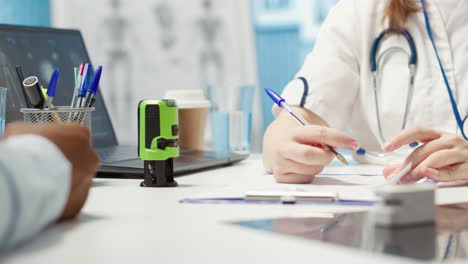 general practitioner putting his stamp on a prescription document