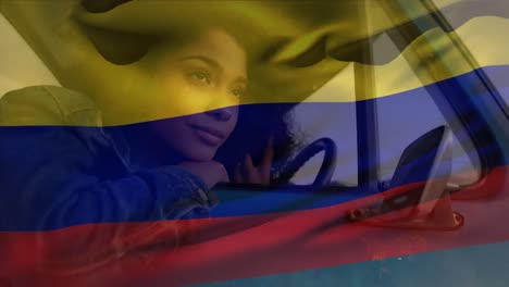 Animation-of-colombian-flag-over-thoughtful-african-american-woman-looking-through-vehicle-window