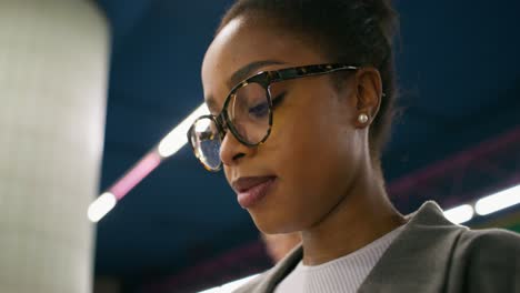 woman in glasses at subway station