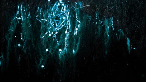 a wave of blue glowing electrical energy rises from the bottom to the top, throwing around sparks and leaving behind blobs of burnt material