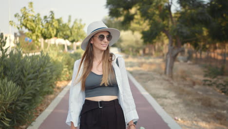 woman walking in park with juice