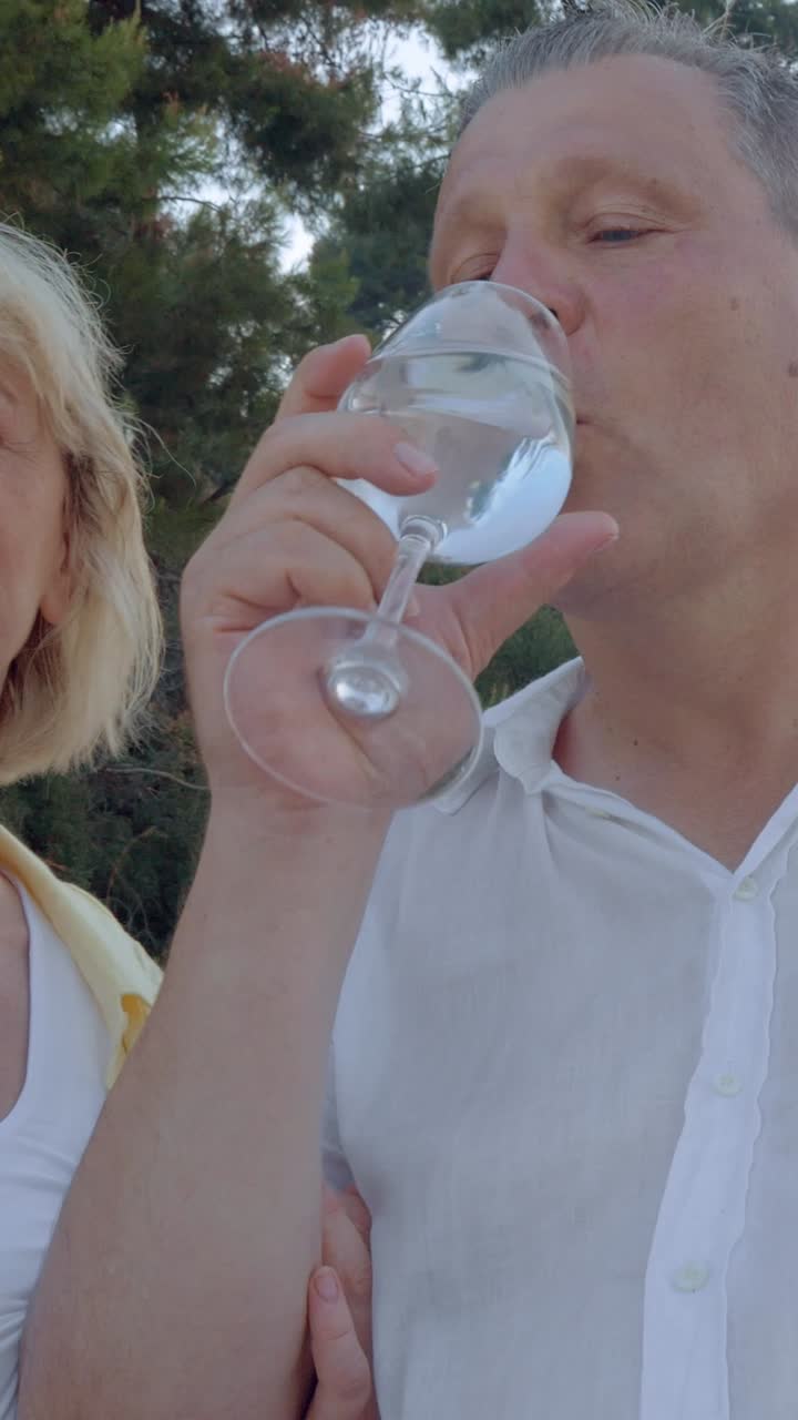 Mature couple enjoying a drink outdoors