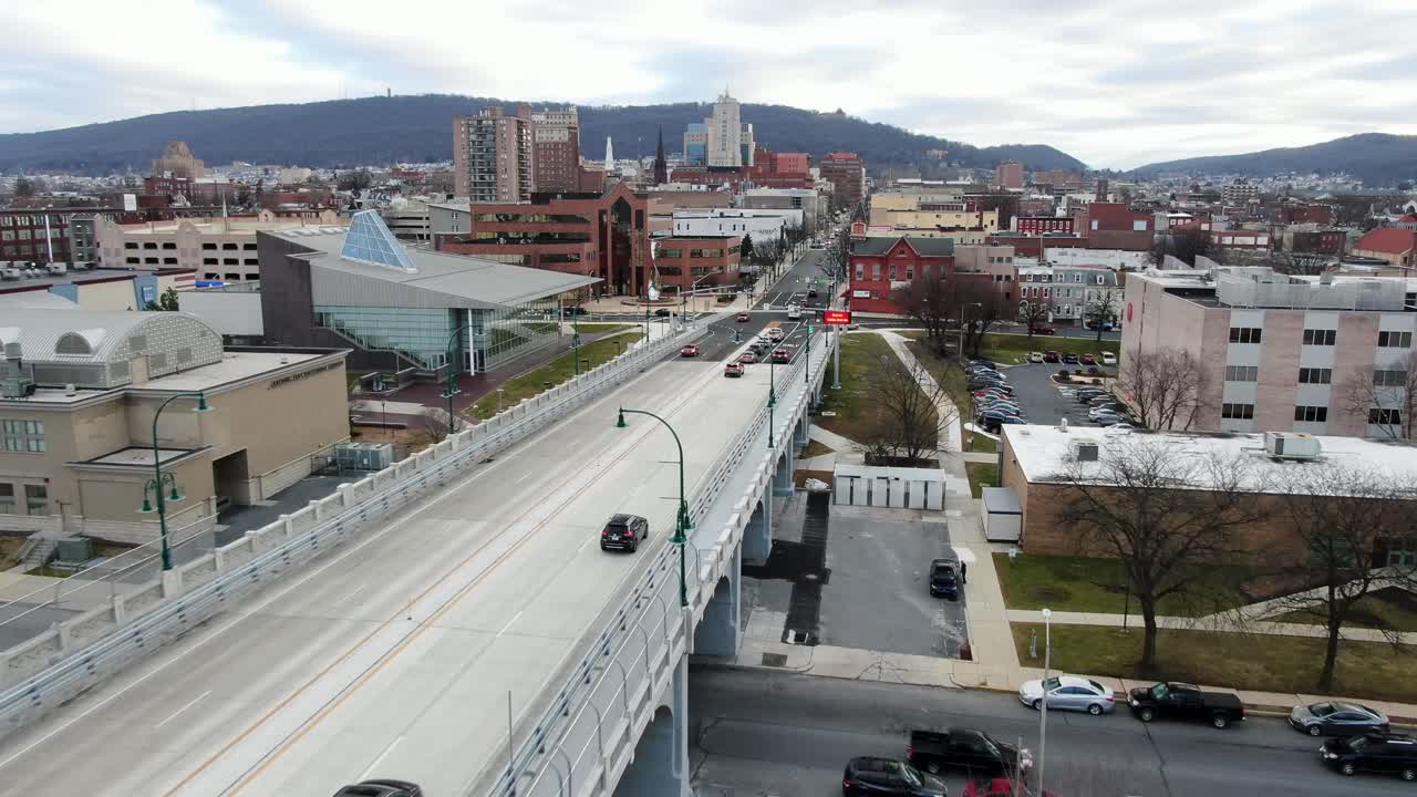 Penn St. bridge crosses Schuylkill River in Berks County, Reading, Pennsylvania, PA city, college, downtown business district, aerial drone view