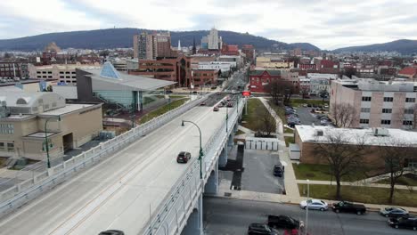 penn st. bridge crosses schuylkill river in berks county, reading, pennsylvania, pa city, college, downtown business district, aerial drone view