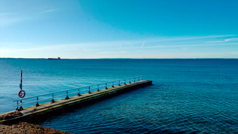 boardwalk-on-empty-beach-near-calm-ocean