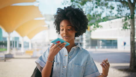 young woman talking on her phone in a city park