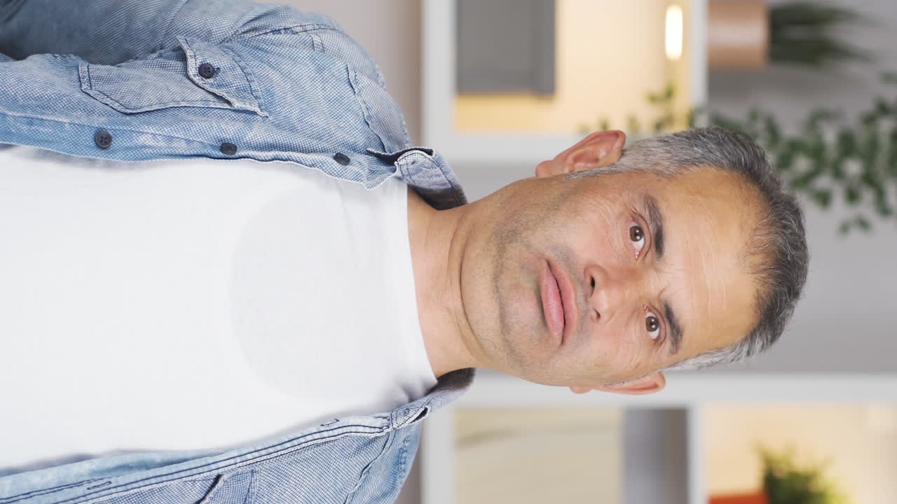 Vertical video of Sleepy man yawns.