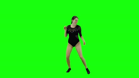 stunning female dancer dancing a modern dance in front of a green screen