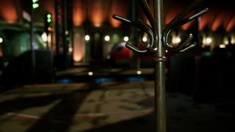 a close up of a vintage wooden coat rack in a dark hallway