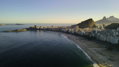 Aerial-pan-shot-of-the-Copacabana-beach-and-the-cityscape-of-Rio-de-Janeiro