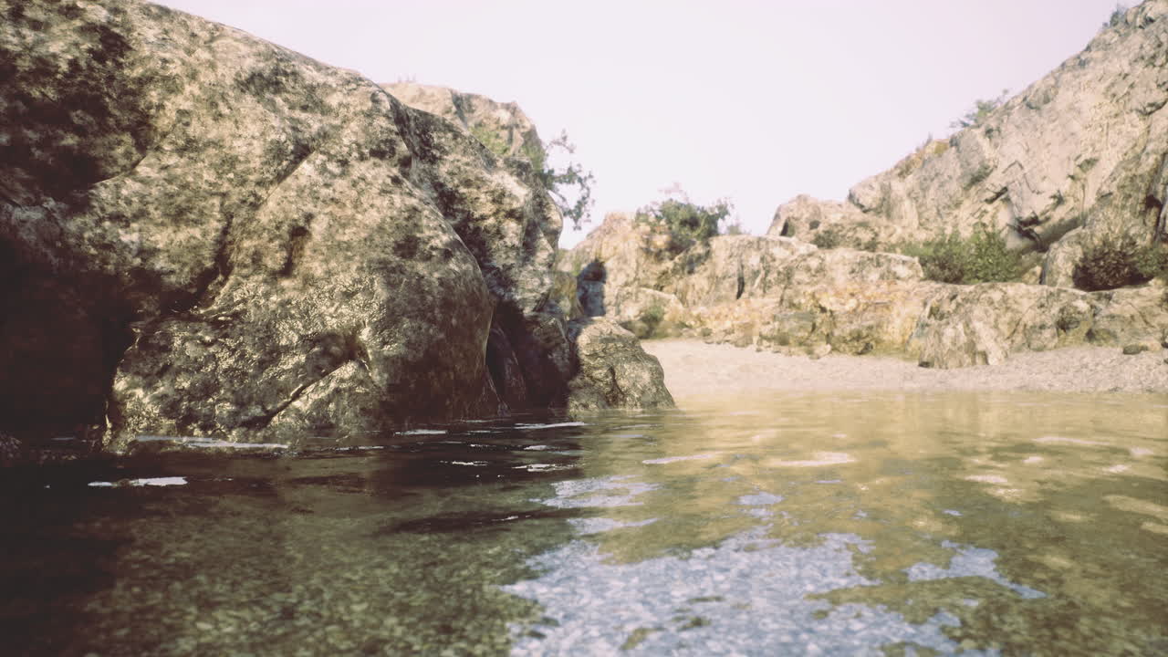 Calm waters reflect rocky landscape in a serene outdoor location