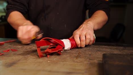 leatherworker shaping red leather