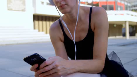 female ballet dancer using mobile phone in the pavement 4k