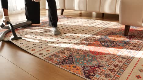 woman vacuuming a carpet in a living room