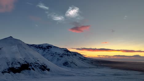 polar stratospheric clouds over snowy mountains in south iceland