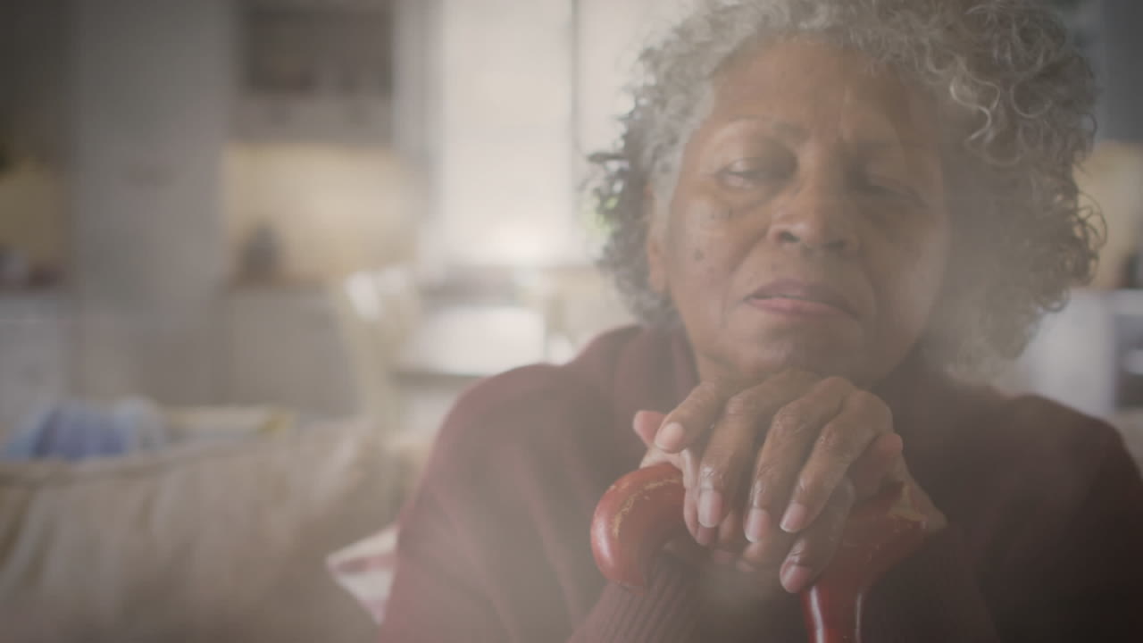 Animation of glowing light over pensive senior woman
