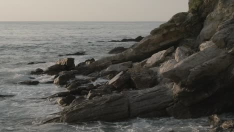 drone flying at low altitude over rocky shore