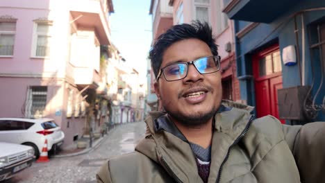 man taking selfie in a city street