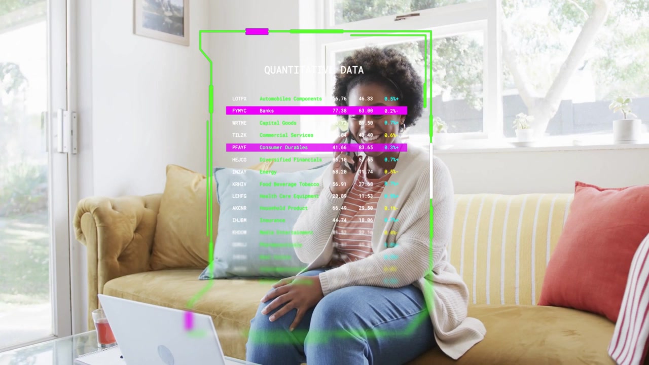 Woman lifting phone to ear and speaking while checking laptop, HUD updating business data on torso