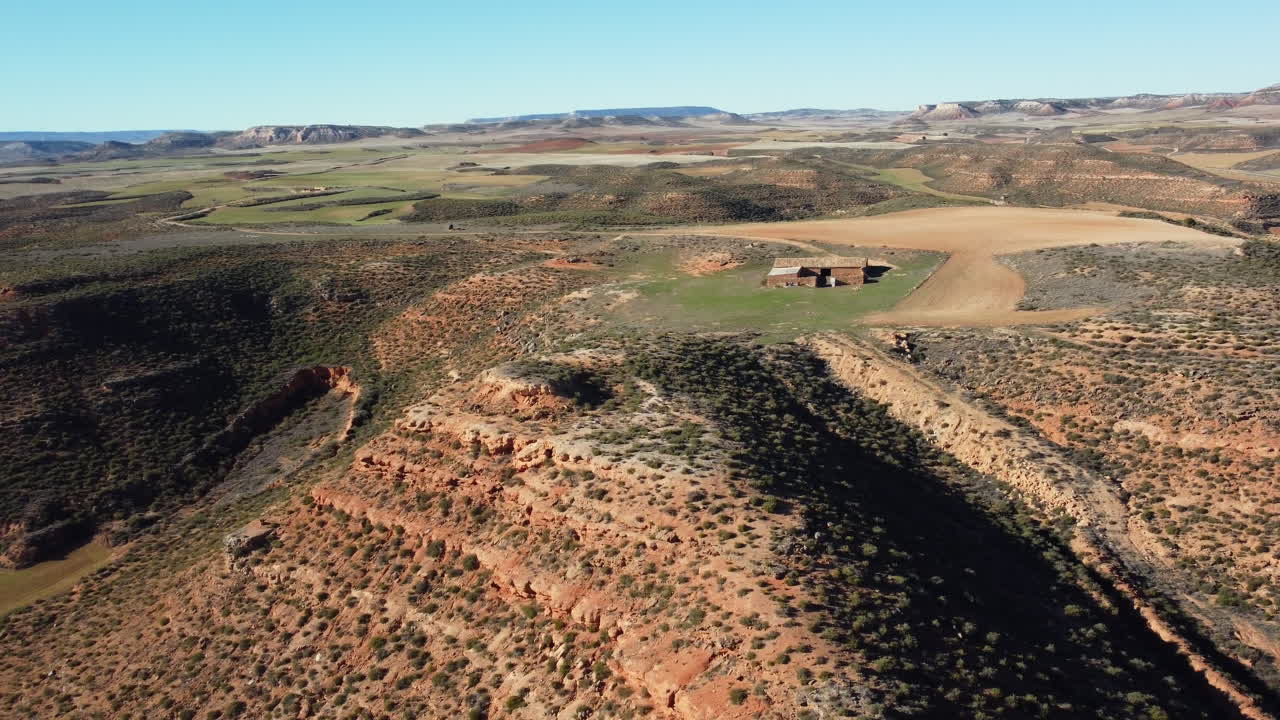 Aerial view of a rural landscape with a farm and hills in Spain