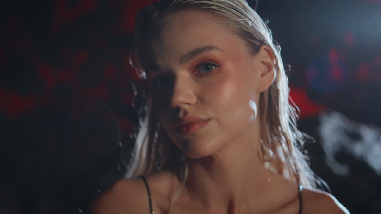 Seductive girl flirting camera at night closeup. Smiling blonde biting lips