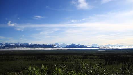 Snow-Covered-Mountains-Peak-Through-Clouds-in-Alaska-Wilderness