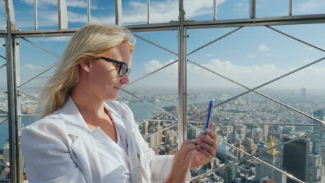 Tourist-Photographs-A-Beautiful-View-Of-The-City-Of-New-York-It-Stands-At-The-Fence-Of-The-Observati