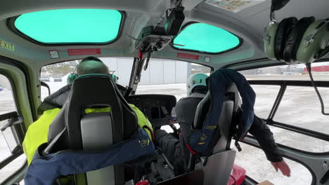 Pilot-closing-the-door-of-a-helicopter-before-take-off-during-the-winter-in-the-arctic