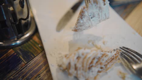 a piece of cake is pricked on a fork and the person eats it. close-up shooting