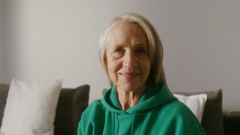 smiling senior woman in a green hoodie