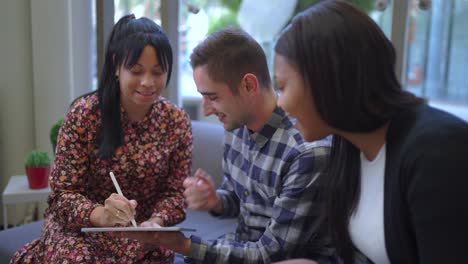 cheerful multiethnic friends browsing on tablet