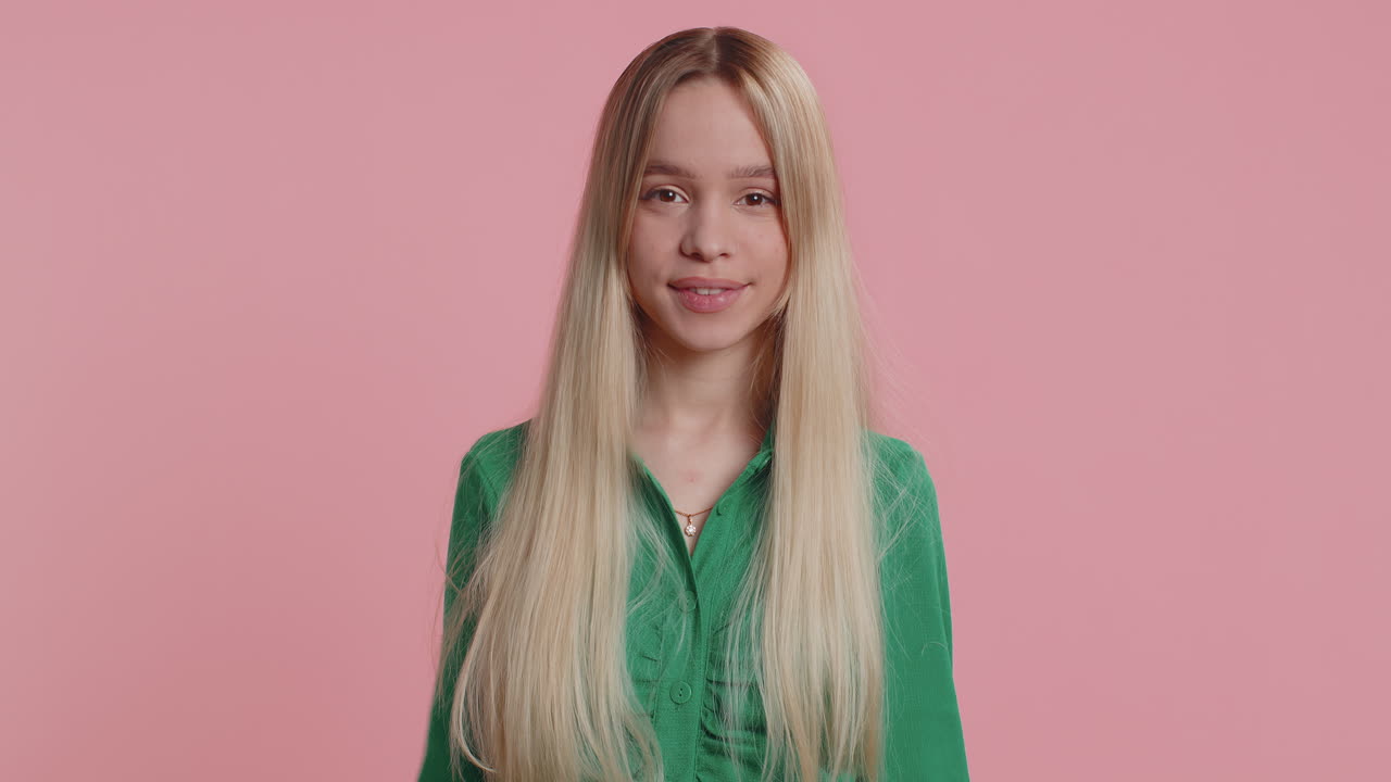 Happy woman girl raises thumbs up agrees or gives positive reply recommends advertisement likes good