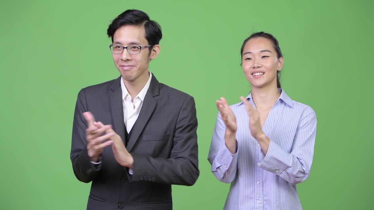 젊은 아시아 비즈니스 커플이 함께 손을 치고 있습니다.