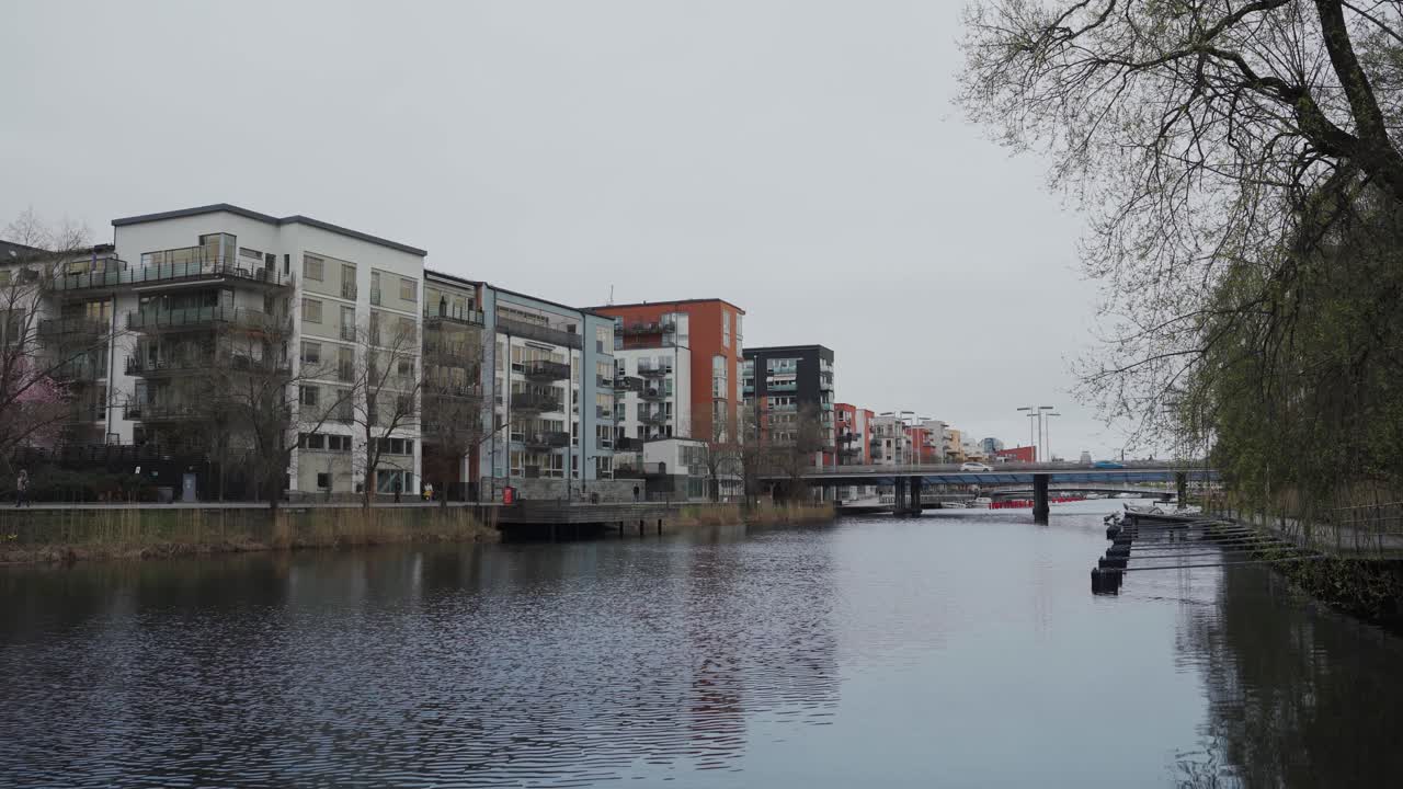 Medium shot of apartment buildings located by a lake.