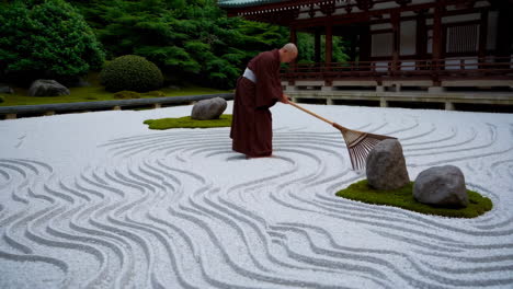 zen monk raking a traditional japanese garden