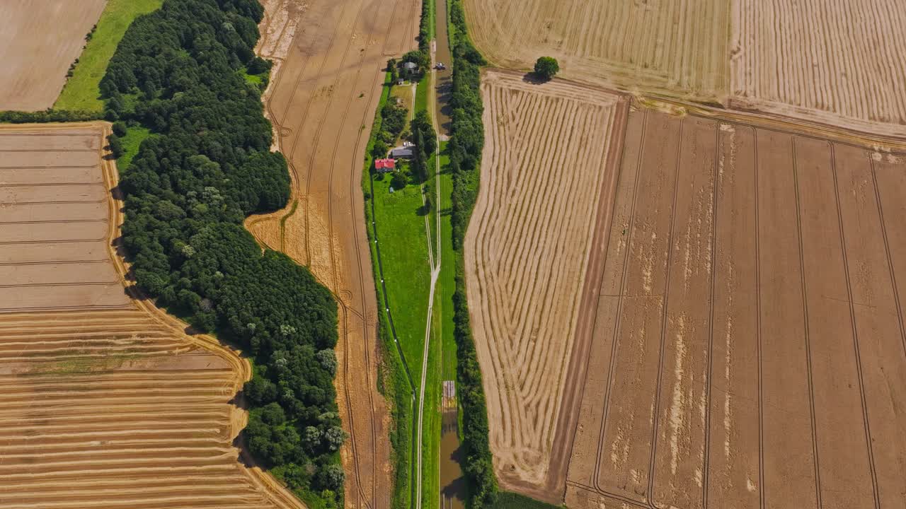 Drone flight over Jelenie Slipway and canal between wheat fields in summer