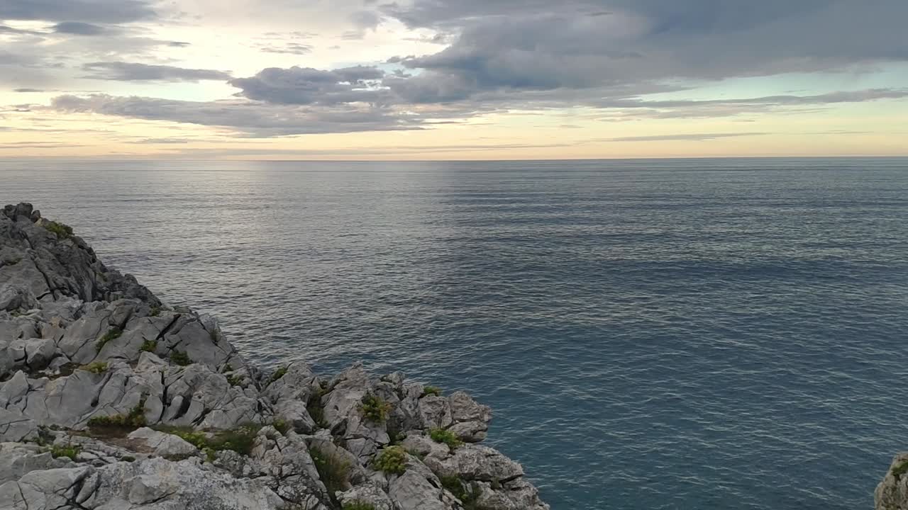 Cliffs meet calm sea under cloudy skies, Guadamia and Tuzarrizu, Asturias coast