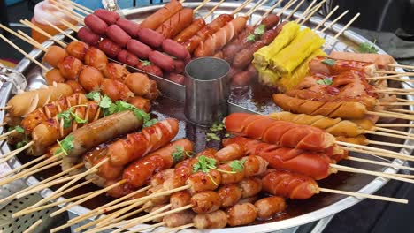 assortment of grilled sausages and other street food