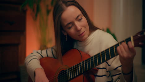 woman playing guitar writing song composing music