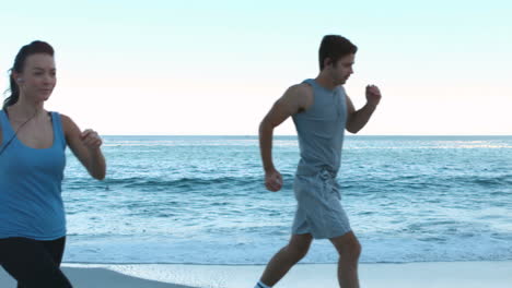 attractive couple running on the beach